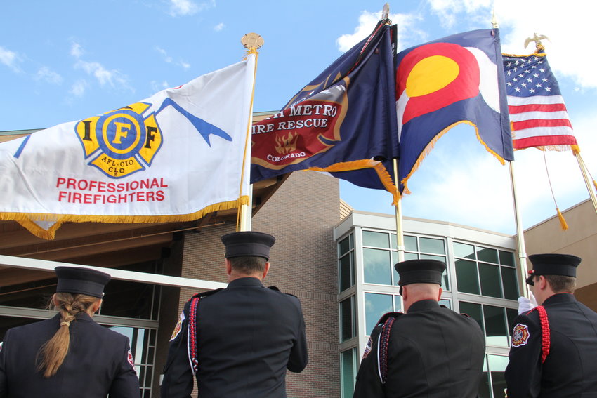 From left, first responders hold up flags for the Colorado Professional Firefighters union, South Metro Fire Rescue, Colorado and the country March 8 at Mission Hills Church in Littleton, near the end of a memorial service for Cody Mooney.